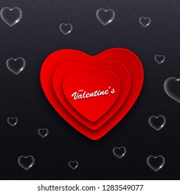 Paper heart shape with stylish lettering of valentine's day on black background decorated with transparent hearts.