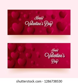 Paper heart shapes decorated on glossy red background with calligraphy of Happy Valentine's Day. Header or banner set design.