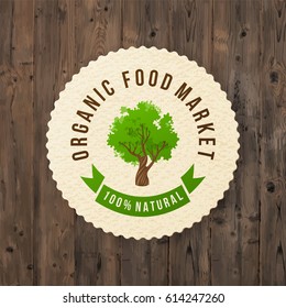 Paper label with type design - Organic food market. 100 natural - on wooden background