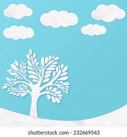 Paper landscape with tree and clouds at blue background