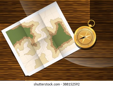 Paper map lying on the table next to the compass.