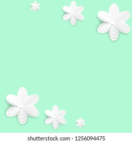 Paper origami flowers on green background.
