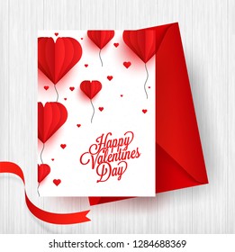 Paper origami of heart shape balloons on white background with envelope for valentine's Day celebration.