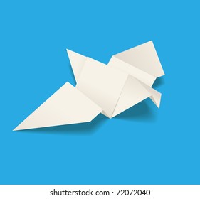 Paper pigeon on blue background