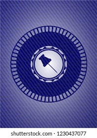 paper pin icon inside badge with denim background