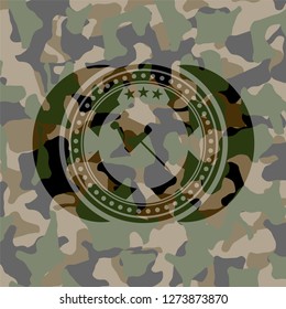 paper pin icon inside camouflaged emblem