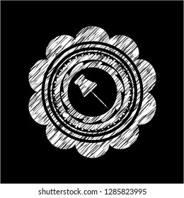 paper pin icon inside chalk emblem written on a blackboard