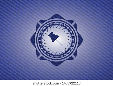 paper pin icon inside denim background