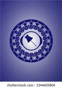 paper pin icon inside emblem with denim texture