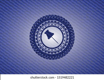 paper pin icon inside emblem with denim texture