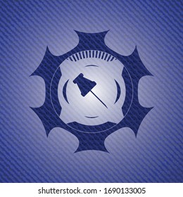 paper pin icon inside emblem with denim texture
