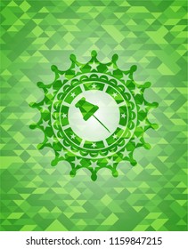 paper pin icon inside green mosaic emblem