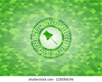 paper pin icon inside green emblem with triangle mosaic background