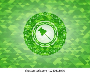 paper pin icon inside green emblem with mosaic background
