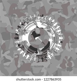 paper pin icon inside grey camo emblem