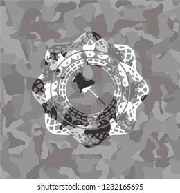 paper pin icon inside grey camouflage emblem