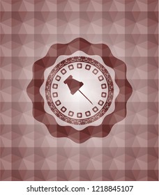 paper pin icon inside red seamless emblem with geometric pattern background.