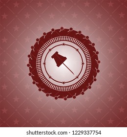paper pin icon inside red emblem