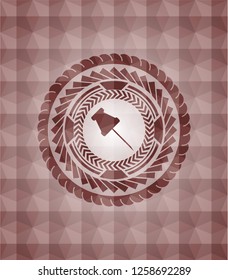 paper pin icon inside red seamless geometric emblem.