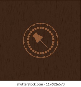 paper pin icon inside retro wooden emblem