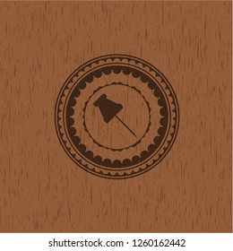 paper pin icon inside retro wooden emblem