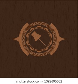 paper pin icon inside wood emblem