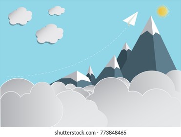 Paper plane flying over a mountain range, paper art concept.
