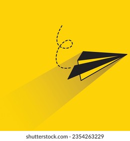 paper plane with shadow on yellow background