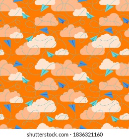 Paper planes with flight traces and clouds colorful seamless vector pattern.