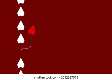 paper planes in a row on red background and one paper glider going in different direction.Opportunity, business progress. Business for innovative solution concept.