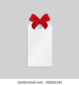 Paper rectangle price tag with red tied bow.