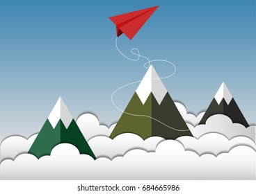 Paper red plane on the clouds and the mountain. Paper art.