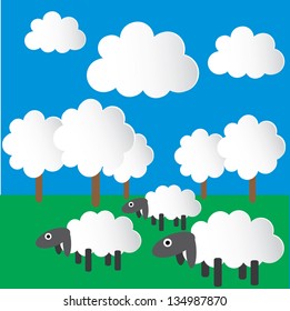 Paper sheep, grazing in the meadow.