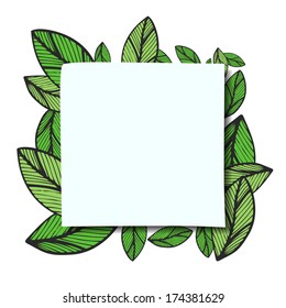 paper sheet on a background of green leaves