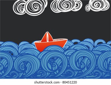 Paper ship floating on blue waves