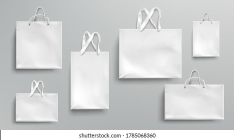 Paper shopping bags mockup, white packages with rope and lace handles, blank rectangular ecological gift packs, isolated mock up for branding and corporate identity design, Realistic 3d vector set