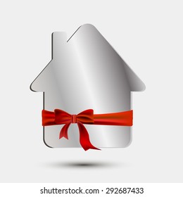 Paper silver house with a red bow and ribbon