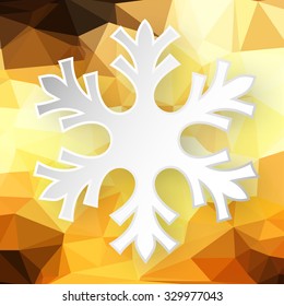 Paper snowflake over abstract geometric background consisting of yellow and brown colored triangles.