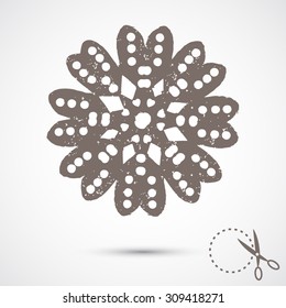 Paper snowflake with scratches on grey background. Silhouette. Handmade, paper cut with scissors. Old style hobby preparation for New year and Christmas Holidays.