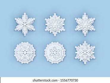 Paper Snowflakes Multilayered Set. Symmetric Papercut snow flake silhouette isolated on blue. Winter season weather decoration icon. Christmas holiday, Noel greeting card. Vector Origami art snowflake