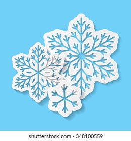 Paper snowflakes on blue background