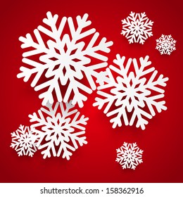 Paper snowflakes on red background