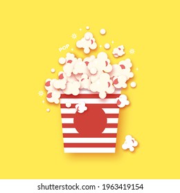 Paper striped bucket. Cup with tasty popcorn paper cut style. Yellow Background. Space for text.