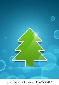 Paper vector green christmas tree sticking out of the divider on blue paper background with lens flare effect.