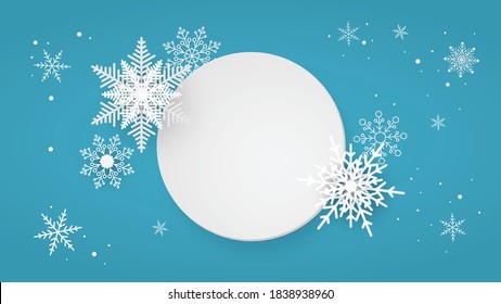 Paper white circle with snowflakes on blue background