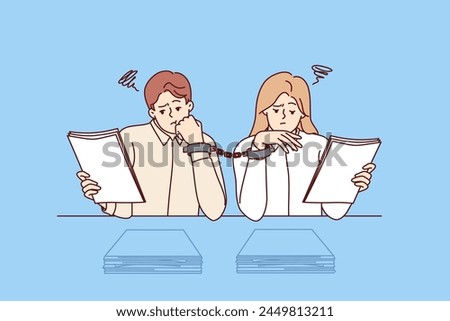 Paperwork forces handcuffed colleagues to do overtime, sitting at desk with papers. Problem of paperwork and excessive bureaucracy in corporations caused by lack of digitalization of work process