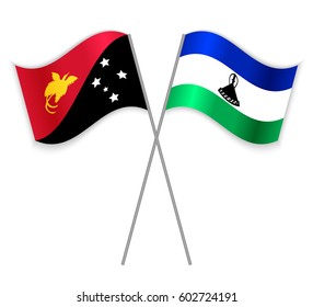Papuan and Basotho crossed flags. Papua New Guinea combined with Lesotho isolated on white. Language learning, international business or travel concept.