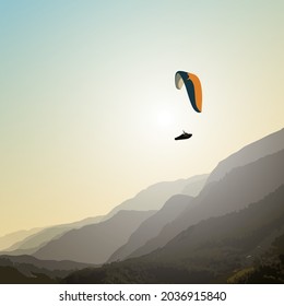 The paraglider flies over the mountains