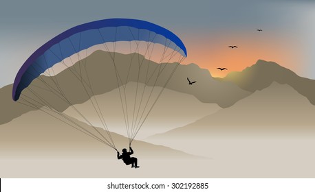 Para-glider hovers over the mountain like a bird