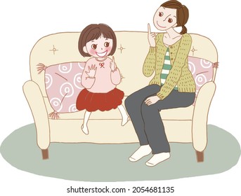 Padre e hijo sentados en el sofá hablando.